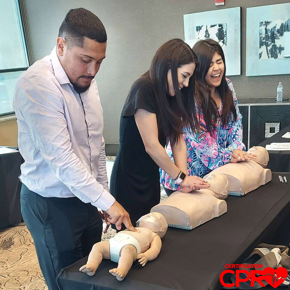 CPR training class in Baltimore with students practicing on mannequins.